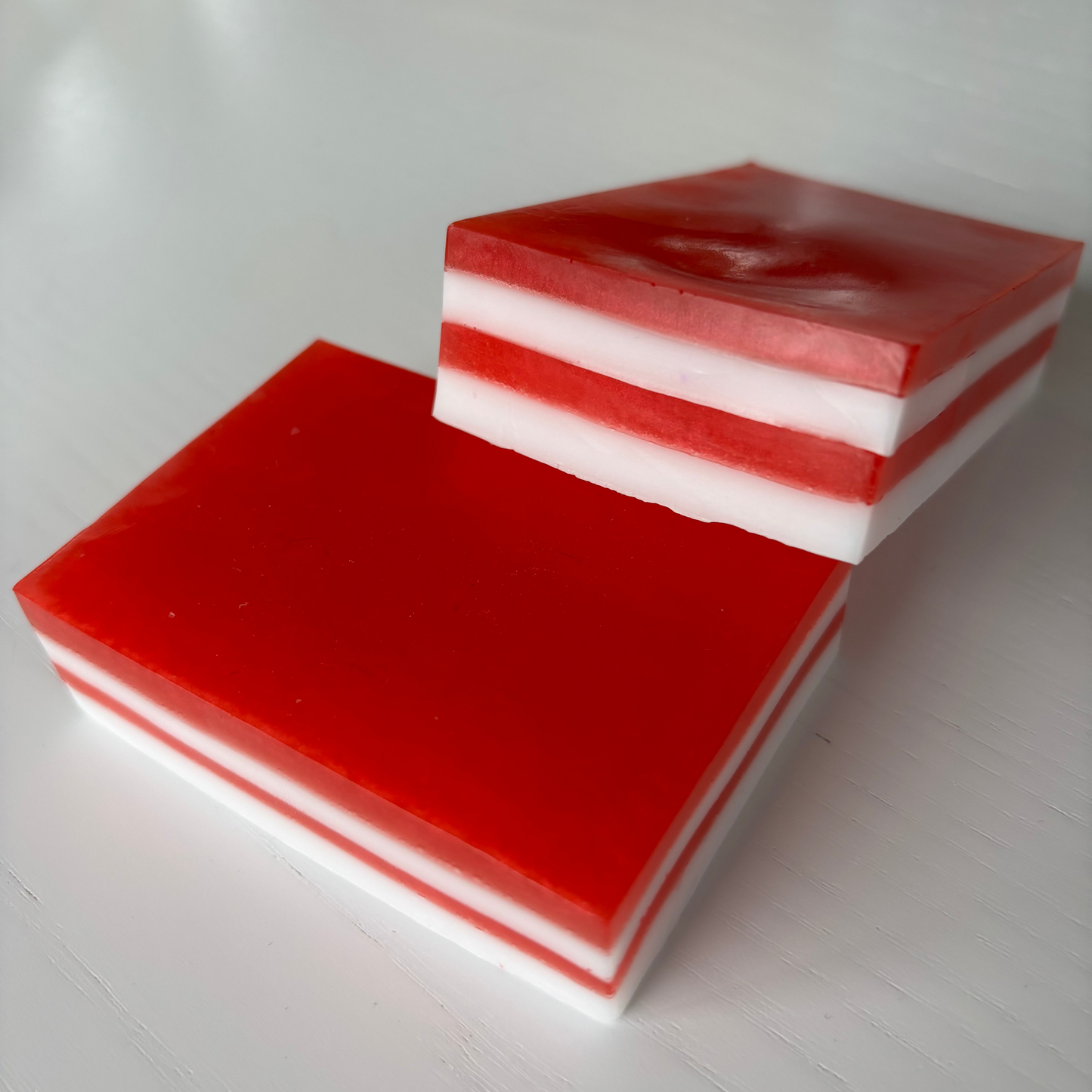 Red and white layered soap on a white surface
