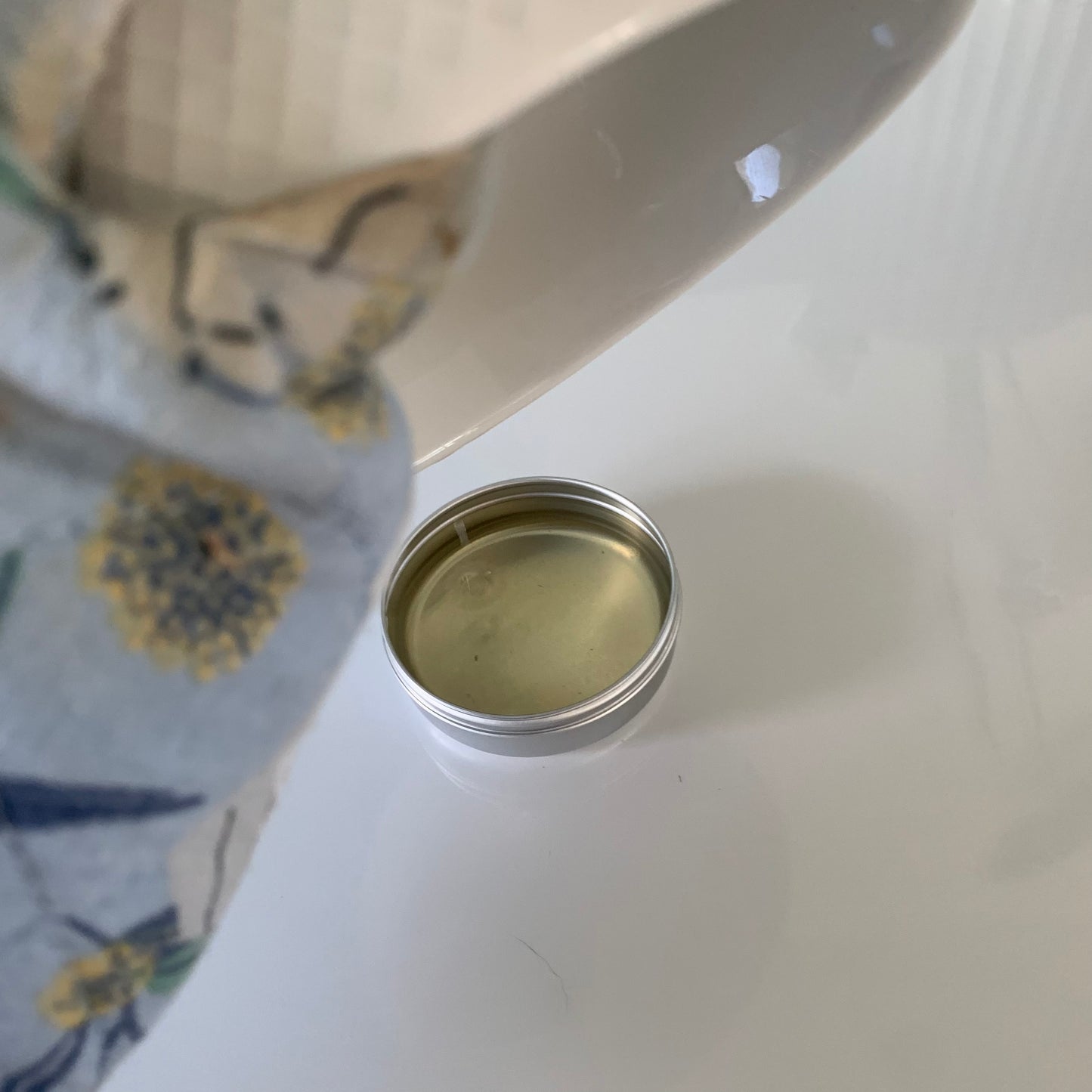 Pouring lavender sleep balm into a pot