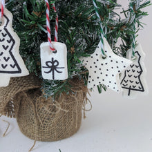 Hand made Christmas decorations hanging on a tree. Clay Christmas tree, present and star decorations.