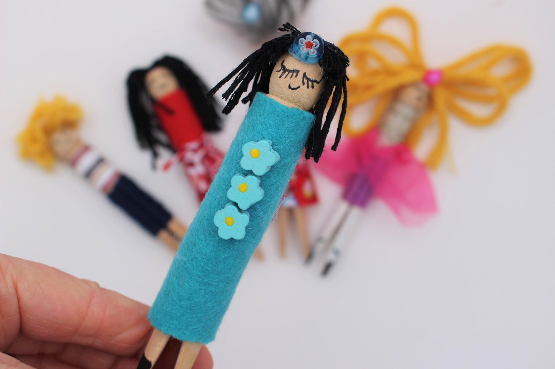 Hand made wooden peg dolls made from a kids craft kit
